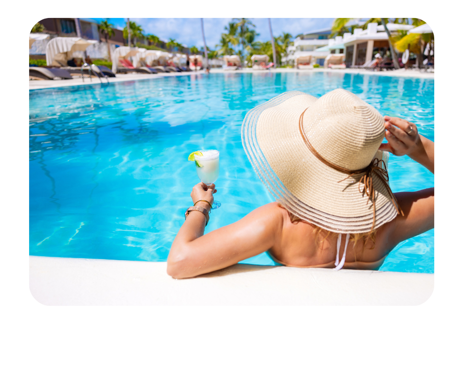 A woman in the pool with a glass