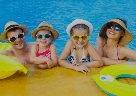 Two parents with his kids in a pool